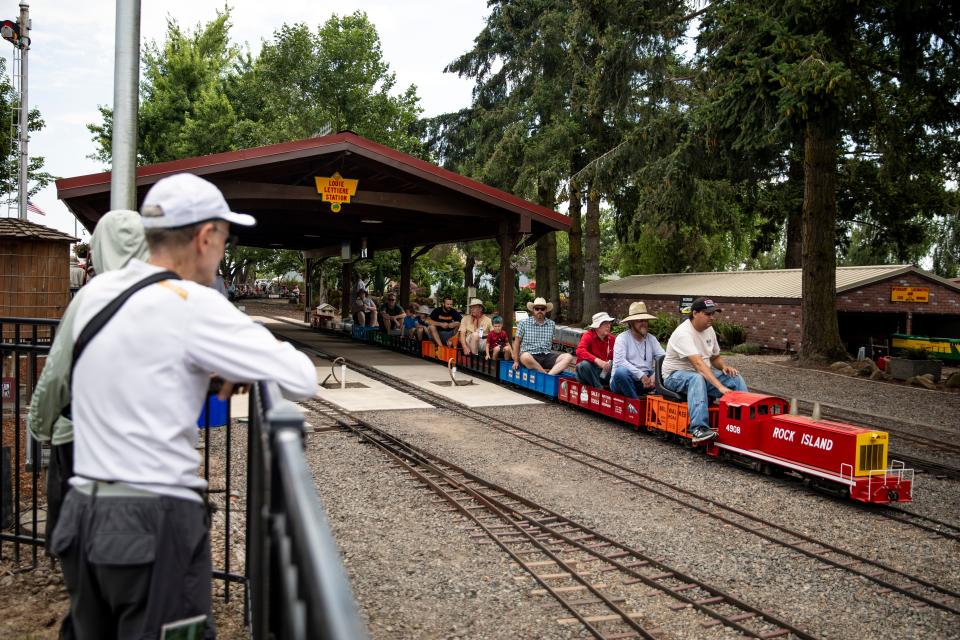 People watch the 1/8 scale train rides ar the Great Oregon Steam-Up in July 2022 at Powerland Heritage Park in Brooks. Crowds gathered at the event to celebrate and learn about the machinery of Oregon's past.