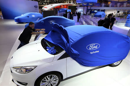 A man unveils a Ford car during the Sao Paulo International Motor Show in Sao Paulo, Brazil, November 8, 2016. REUTERS/Paulo Whitaker