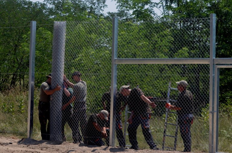 Local soldiers of the Hungarian Army's technical unit set up the first parts of the 150 meter-long fence at the Hungarian-Serbian border on July 16, 2015