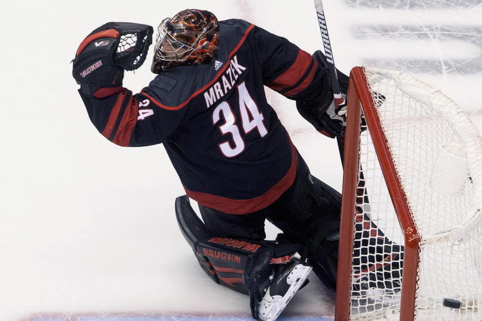 Carolina Hurricanes goaltender Petr Mrazek (34) watches as the puck goes wide of the goal during third period NHL Eastern Conference Stanley Cup playoff game in Toronto on Saturday, Aug. 15, 2020. (Chris Young/The Canadian Press via AP)