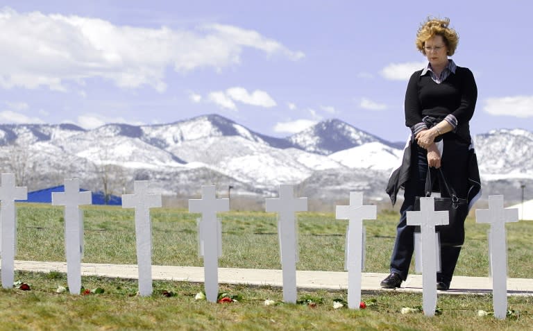 Donna Polodna of Highlands Ranch, Colorado looks at some 13 crosses representing the Columbine High School shooting victims