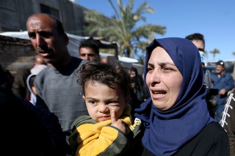 Relatives of three Palestinian fishermen from Allaham family mourn during their funeral in Khan Younis in the southern Gaza Strip