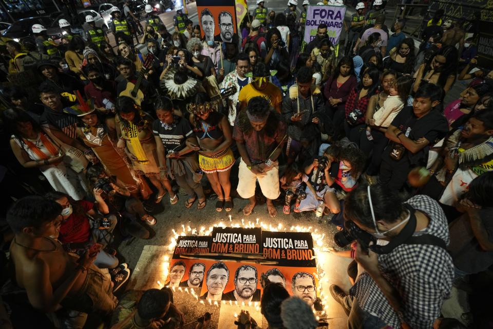 FILE - Guarani Indigenous people and human rights activists attend a vigil in Sao Paulo, Brazil, June 23, 2022, demanding the Supreme Court define the boundaries of Indigenous lands and asking for justice in the deaths of British journalist Dom Phillips and Indigenous expert Bruno Pereira. As the one-year anniversary of the murders approached, The Associated Press returned to the Javari Valley to describe the place where the two were killed. (AP Photo/Andre Penner, File)