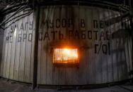 A melting furnace is seen inside Eurasian Resources Group's (ERG) Aksu Ferroalloys Plant in the town of Aksu, north-eastern Kazakhstan, February 19, 2018. The sign reads: "Do not throw paper, rubbish into the furnace, gas cleaning works!" REUTERS/Shamil Zhumatov/Files