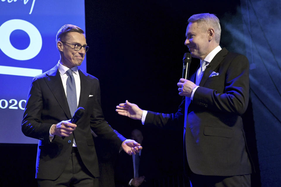 National Coalition Party presidential candidate Alexander Stubb, left, joins Green Party backed candidate Pekka Haavisto on stage at his election reception, in Helsinki, Finland, Sunday, Feb. 11, 2024. Alexander Stubb is projected to win Finland’s presidential election runoff on Sunday against the former Foreign Minister Pekka Haavisto. (Vesa Moilanen/Lehtikuva via AP)