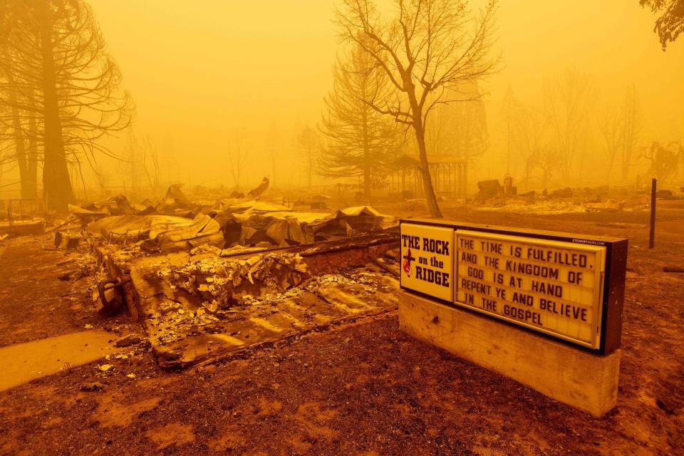 A burned church rests in heavy smoke during the Dixie fire in Greenville, California on Aug. 6, 2021.