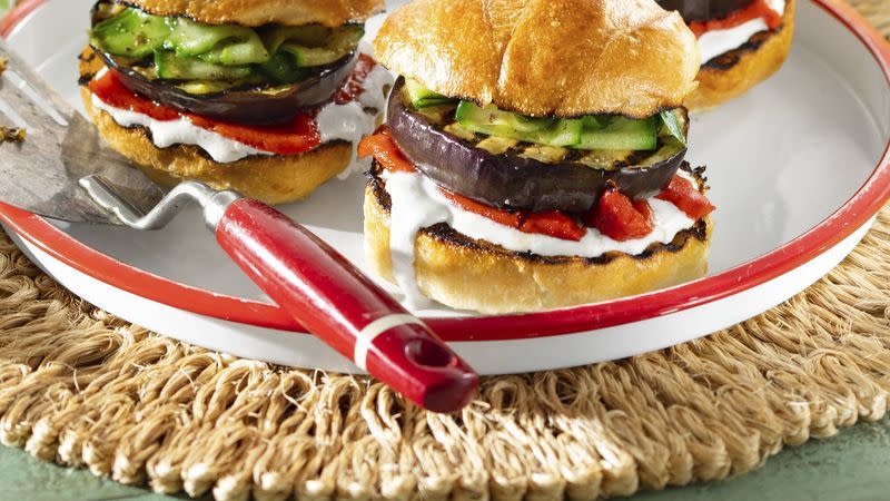 eggplant burgers arranged on a white tray with red trim