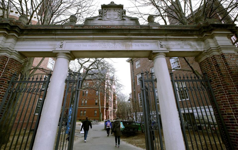 FILE - A gate opens to the Harvard University campus Dec. 13, 2018, in Cambridge, Mass. There is one college football conference sitting out the reshuffling going on among its big-money brethren: The Ivy League will start the season with the same eight members it has had since it formed in 1956. (AP Photo/Charles Krupa, File)