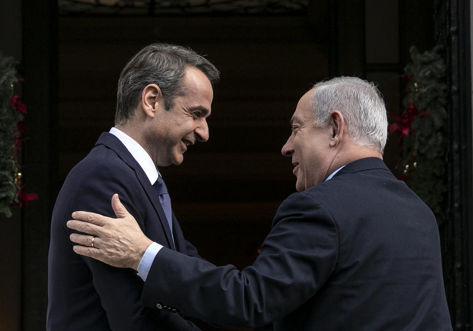 Greece's Prime Minister Kyriakos Mitsotakis, left, welcomes his Israeli counterpart Benjamin Netanyahu in Athens, Thursday, Jan. 2, 2020. The leaders of Greece, Israel and Cyprus will meet in Athens Thursday to sign a deal aiming to build a key undersea pipeline, named EastMed, designed to carry gas from new rich offshore deposits in the southeastern Mediterranean to continental Europe. (AP Photo/Yorgos Karahalis)