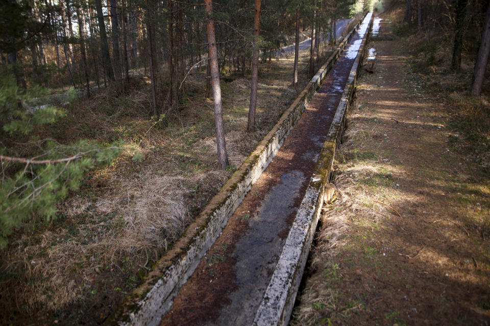 The destroyed bobsleigh track on Trebevic mountain near Sarajevo, Bosnia, Wednesday, Feb. 7, 2024. The bobsleigh track area was a Bosnian-Serb artillery stronghold during the war 1992-1995 Bosnian war. Sarajevo is paying tribute this week to one of its most glorious moments: the two weeks of February in 1984 when it staged an impeccable Winter Olympic Games. While taking the nostalgic trip down memory lane, Bosnian Olympians say they are looking to the future with hope to again pull off an “apparently impossible feat” and reignite the Olympic flame over Sarajevo in 2032. (AP Photo/Armin Durgut)