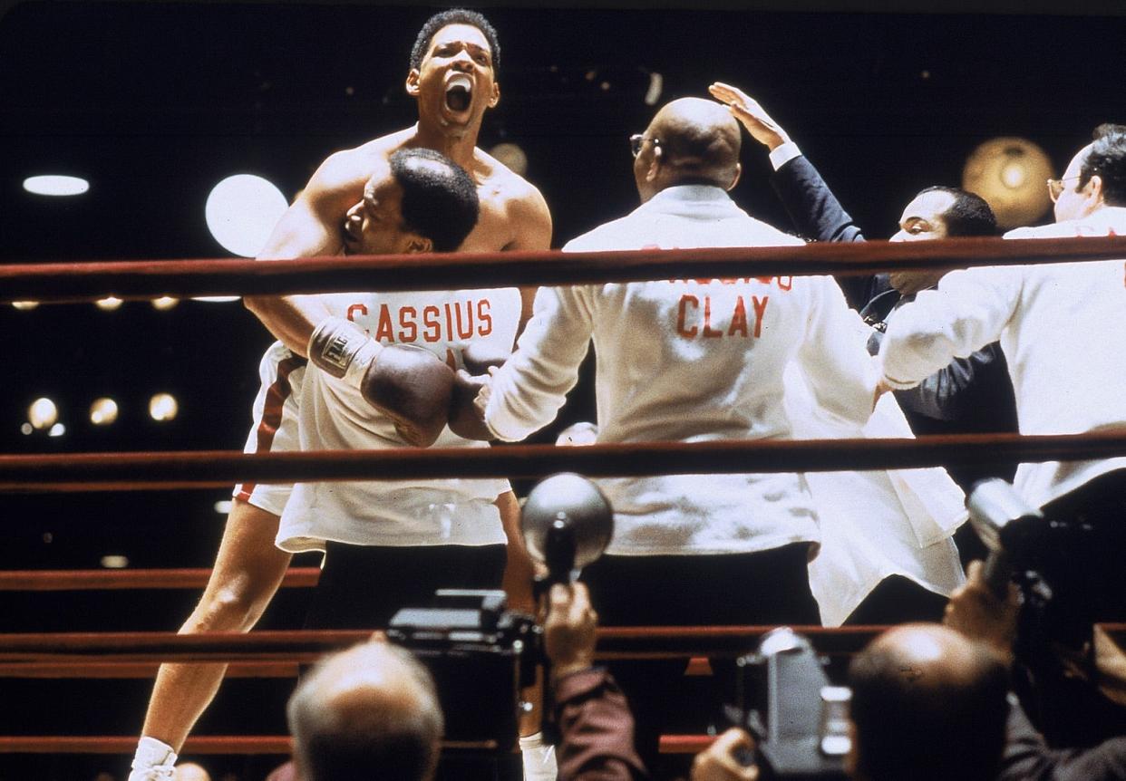 Drew "Bundini" Brown (Jamie Foxx, bottom center) lifts up Muhammad Ali (Will Smith) after a victory in "Ali."
