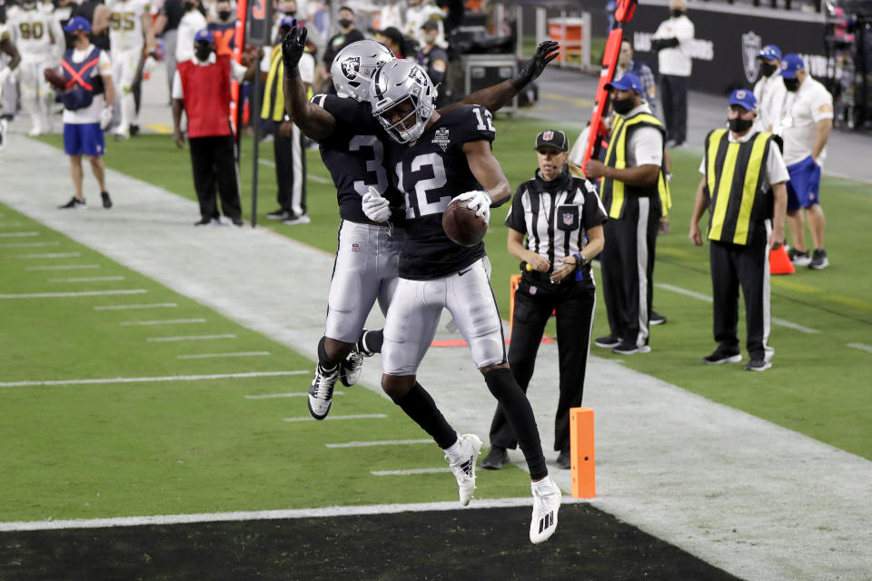 Las Vegas Raiders running back Jalen Richard, left, celebrates after wide receiver Zay Jones (12) scored a touchdown against the New Orleans Saints during the first half of an NFL football game, Monday, Sept. 21, 2020, in Las Vegas. (AP Photo/Isaac Brekken)