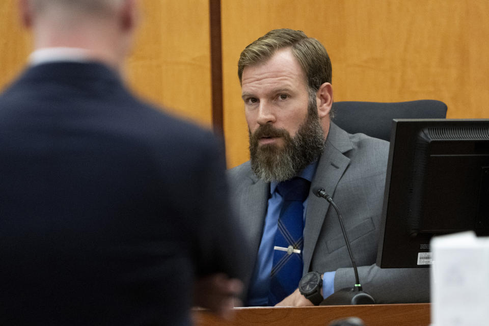 Defendant Matthew Collins testifies under direct examination by his attorney Jared Ausserer during the trial of three Tacoma Police officers in the killing of Manny Ellis, at Pierce County Superior Court, Monday, Dec. 4, 2023, in Tacoma, Wash. Tacoma Police Officers Christopher Burbank, Matthew Collins and Timothy Rankine stand trial for charges related to the March 2020 killing of Ellis. (Brian Hayes/The News Tribune via AP, Pool)