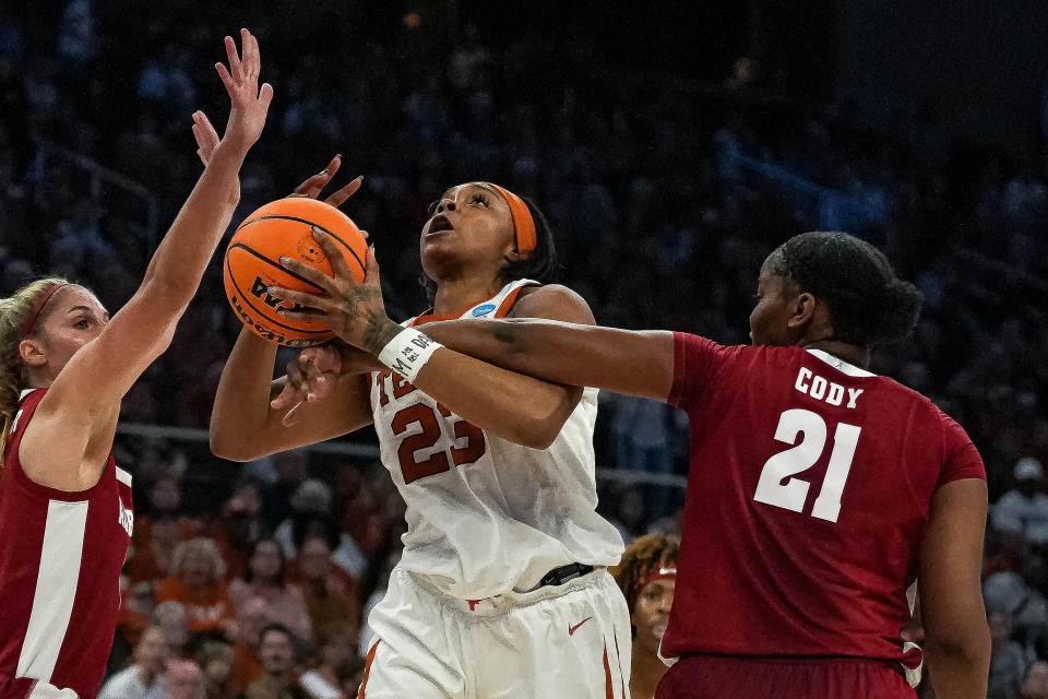 Texas forward Aaliyah Moore is fouled while shooting by Alabama forward Essense Cody during Sunday's second-round matchup of the NCAA Women's Tournament at Moody Center. At stake is a berth in the Sweet 16.