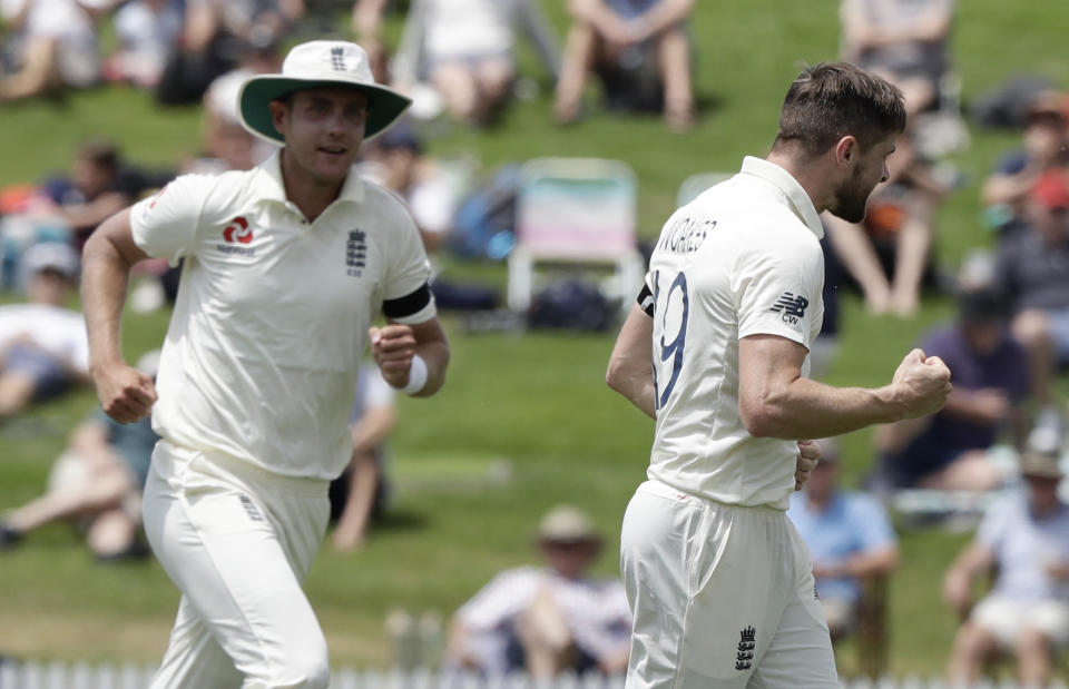 England's Chris Woakes, right, celebrates after dismissing New Zealand's Kane Williamson during play on day one of the second cricket test between England and New Zealand at Seddon Park in Hamilton, New Zealand, Friday, Nov. 29, 2019. (AP Photo/Mark Baker)