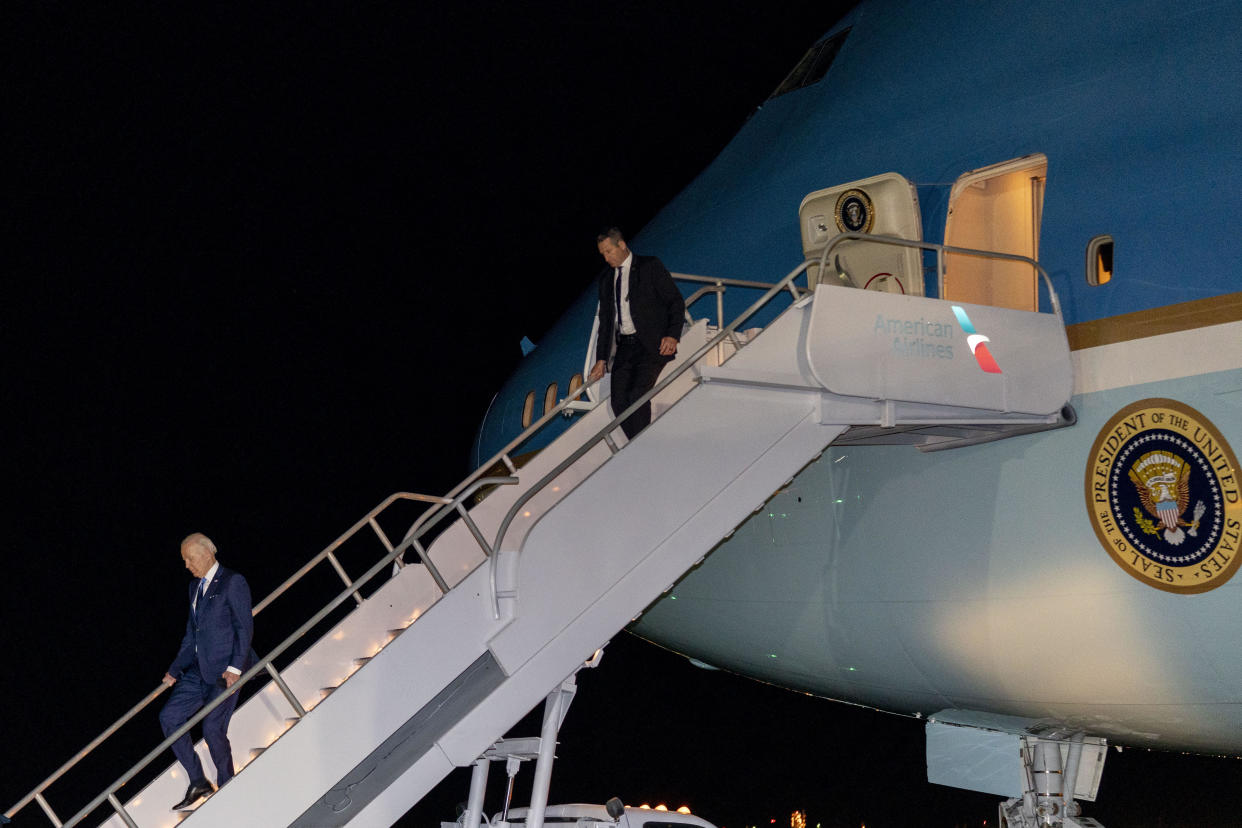 President Joe Biden, left, leaves Air Force One at Philadelphia International Airport in Philadelphia early Saturday, April 23, 2022, to board Marine One for a short trip to Wilmington, Del., for the weekend. / Credit: Andrew Harnik / AP