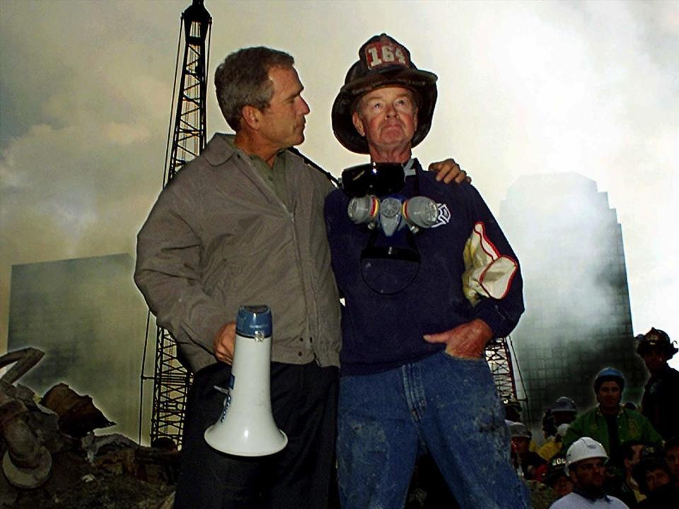 George W. Bush puts arm around firefighter Bob Beckwith, at World Trade Center crash site in New York City. / Credit: The Associated Press