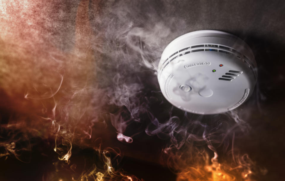 Flames surrounding a smoke detector