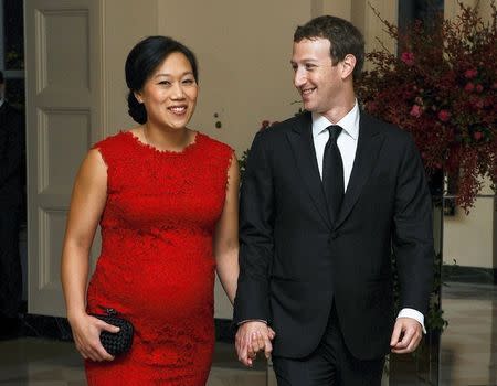 Mark Zuckerberg, Chairman and CEO of Facebook, and his wife Priscilla Chan arrive for an official State dinner at the White House in Washington, in this September 25, 2015 file photo. REUTERS/Mary F. Calvert