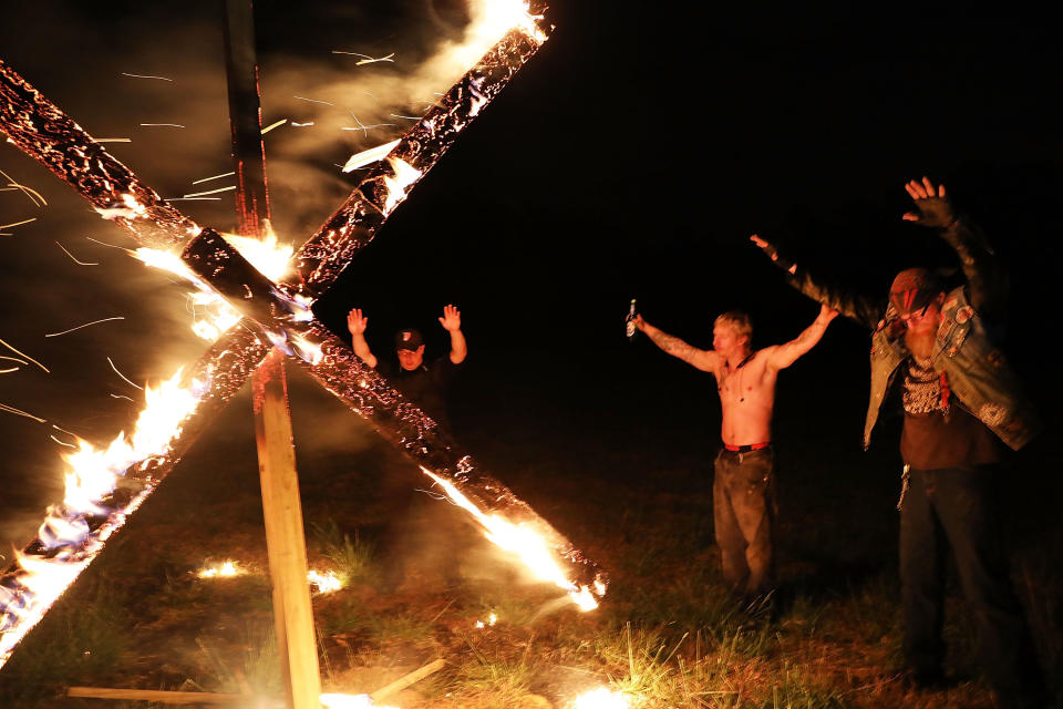 Members of the National Socialist Movement, one of the largest neo-Nazi groups in the US, hold a swastika burning after a rally on April 21, 2018 in Draketown, Georgia. Community members had opposed the rally in Newnan and came out to embrace racial unity in the small Georgia town. Fearing a repeat of the violence that broke out after Charlottesville, hundreds of police officers were stationed in the town during the rally in an attempt to keep the anti racist protesters and neo-Nazi groups separated