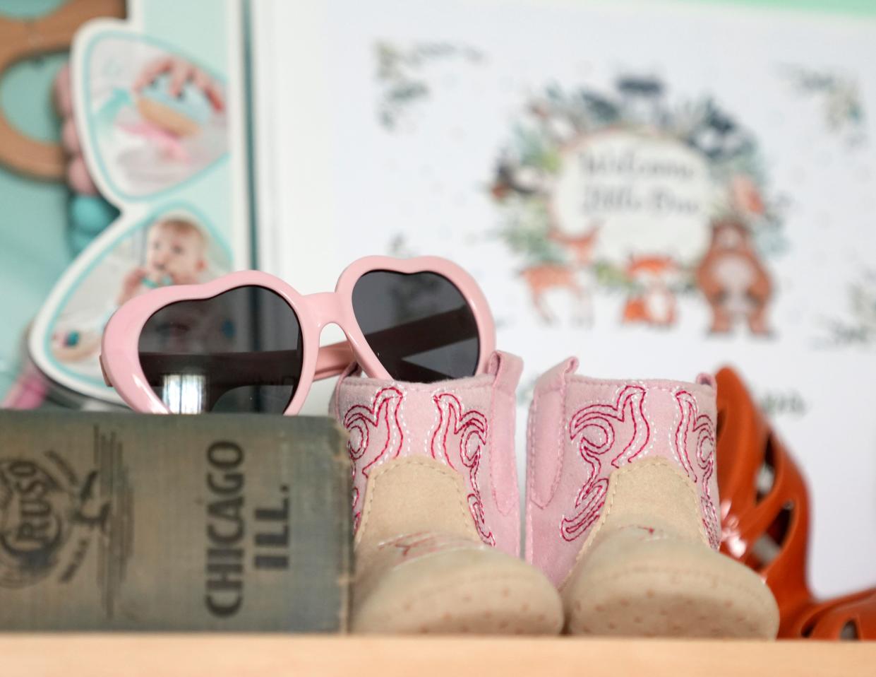 Tiny pink sunglasses and boots are seen Tuesday on a shelf in the nursery intended for Elleanor Hayes, who was three weeks away from being born when her mother, Nellie Hayes, died from a pulmonary embolism caused by a placental abruption at the end of March.