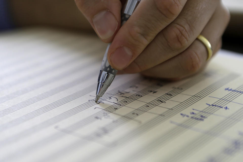 Yotam Haber works out the finishing touches of his composition "A More Convenient Season" in his office at the University of New Orleans on Thursday, Sept. 5, 2013. "For this piece to resonate out with others, there needs to be a larger message here," says Haber, whose family's losses during the Nazi Holocaust informed his work. "And the message is that we cannot sit idly by when we see injustice. We need to act." (AP Photo/Gerald Herbert)