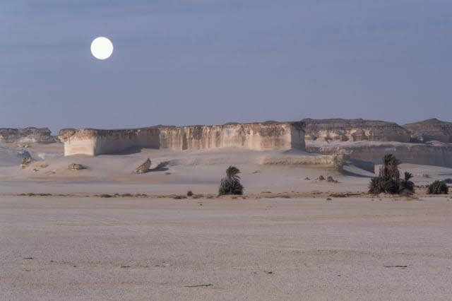 View of El Arag at dawn with moon, Sahara desert