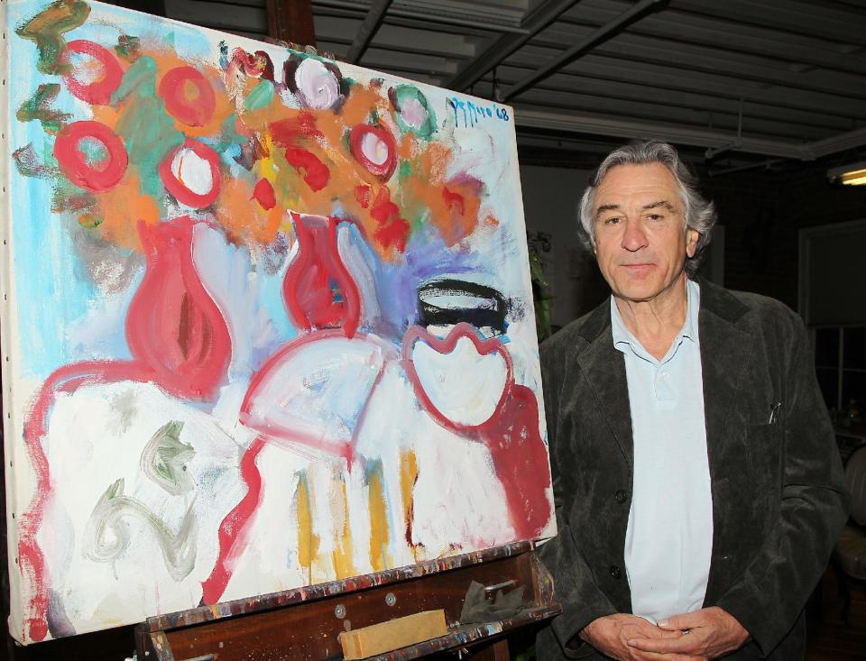 FILE - In this Wednesday, Nov. 17, 2010 file photo released by Starpix, actor Robert De Niro stands next to a painting executed by his father, Robert De Niro Sr., in New York. De Niro has made a documentary about his father, abstract expressionist painter Robert De Niro Sr., called "Remembering the Artist Robert De Niro Sr," which premiered at Sundance Film Festival and will air on HBO in June 2014.(AP Photo/Starpix, Dave Allocca, File)