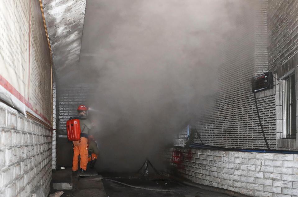 <p>Rescue workers at the entrance of the coal mine in Yongchuan District of Chongqing, southwestern China</p> (AP)