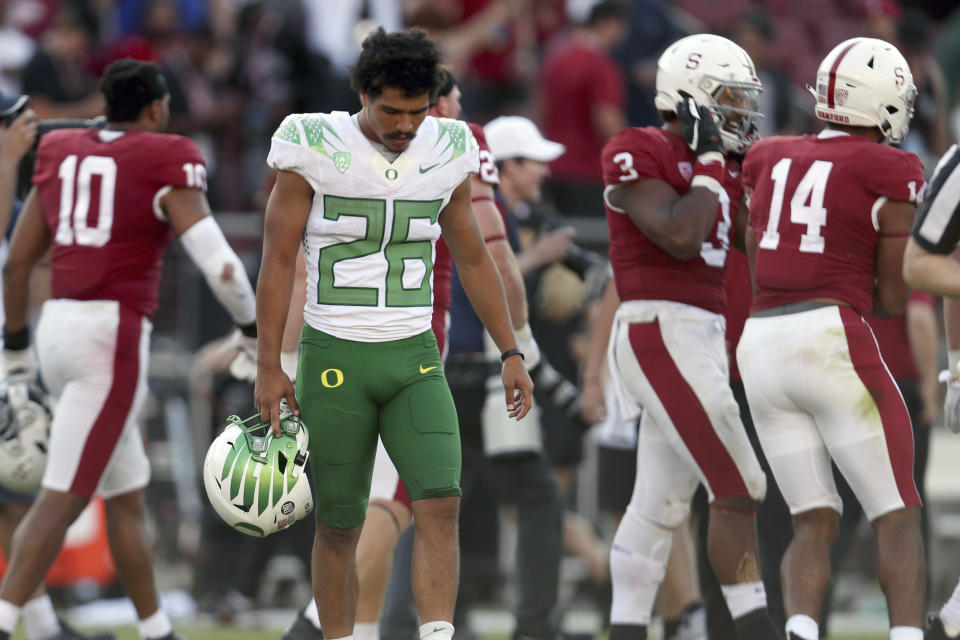 Oregons' Travis Dye (26) walks off the field after losing to Stanford after overtime in an NCAA college football game in Stanford, Calif., Saturday, Oct. 2, 2021. (AP Photo/Jed Jacobsohn)