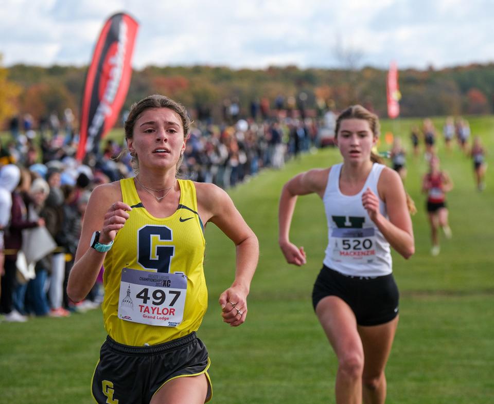 Taylor Pangburn (497) from Grand Ledge holds off Howell's Mackenzie Wright (520) to secure a fourth place finish in the Girls Greater Lansing Cross Country Championships Saturday, Oct. 15, 2022.