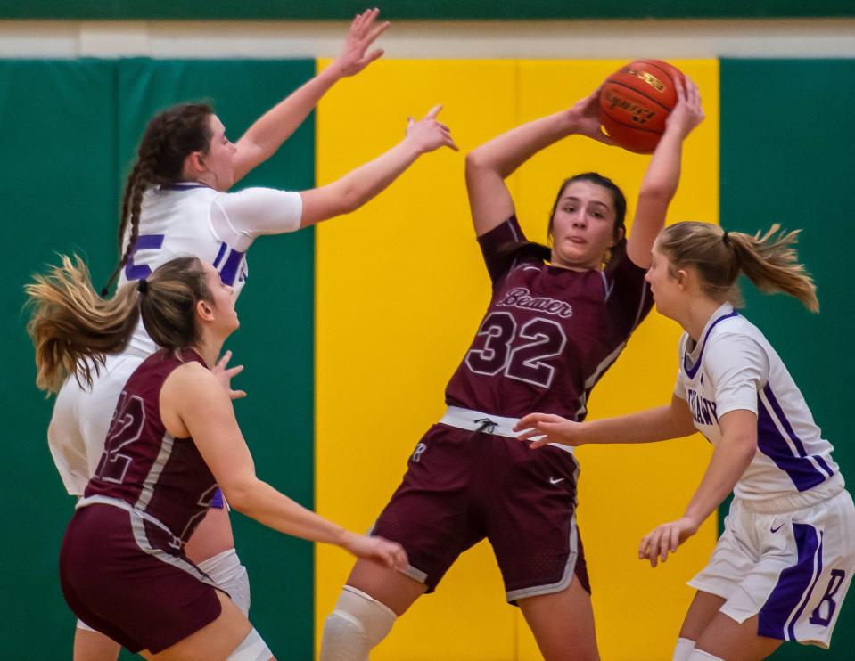 Beaver's Payton List grabs a rebound from Blackhawk's Quinn Borroni during their game Thursday at Blackhawk High School. Beaver's Hailey Tooch is below left, Blackhawk's Lizzie Troup is at right. [Lucy Schaly/For BCT]