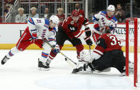 New York Rangers center Brett Howden (21) plays the puck in front of Arizona Coyotes goalie Darcy Kuemper (35) as Arizona Coyotes' Ilya Lyubushkin (46) defends during the first period of an NHL hockey game, Sunday, Jan. 6, 2019, in Glendale, Ariz. (AP Photo/Ralph Freso)