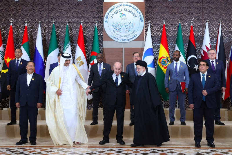 President of Algeria Abdelmadjid Tebboune (C), Iranian President Ebrahim Raisi (4th R), and the Emir of Qatar Tamim bin Hamad Al Thani (3rd L) prepare for a group photo with other participants during the 7th Gas Exporting Countries Forum (GECF) Summit in Algiers. -/Iranian Presidency/dpa