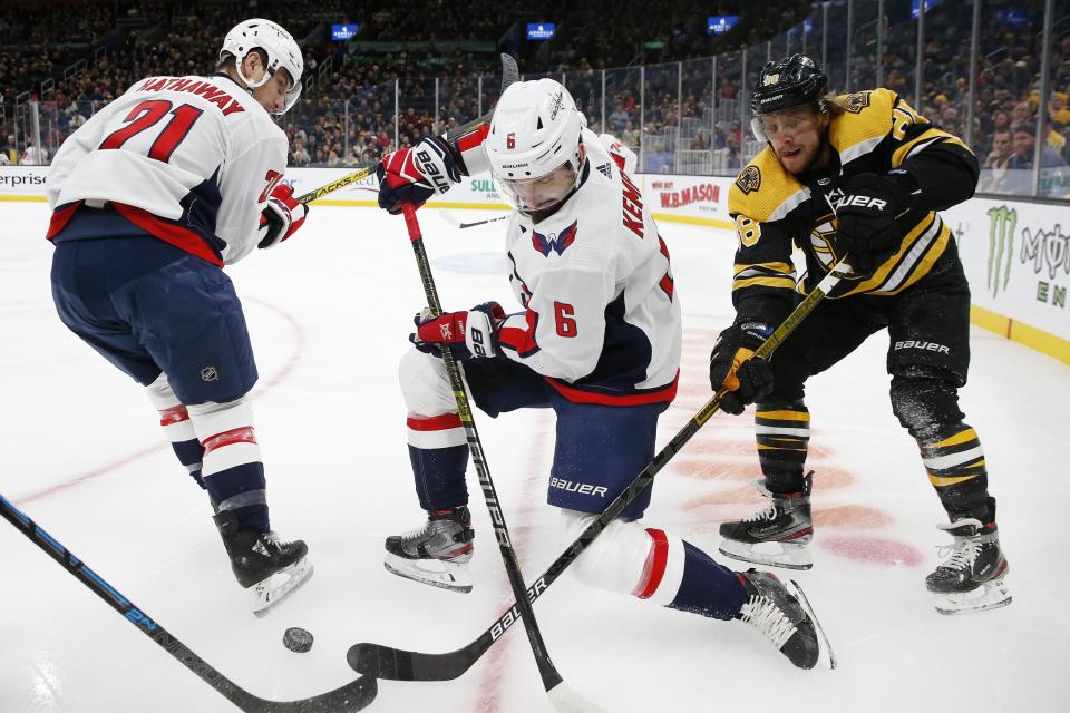 Boston Bruins' David Pastrnak (88) competes against Washington Capitals' Michal Kempny (6) for the puck during the first period of an NHL hockey game in Boston, Saturday, Nov. 16, 2019. (AP Photo/Michael Dwyer)