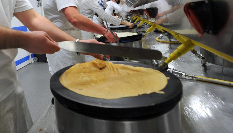 At a cafe and sweet shop in central Prague, Zuzana Auerova brings a chocolate-banana crepe to a guest, then hesitates: does the fork go on the right or the left of the plate? AFP Photo / Frank Perry