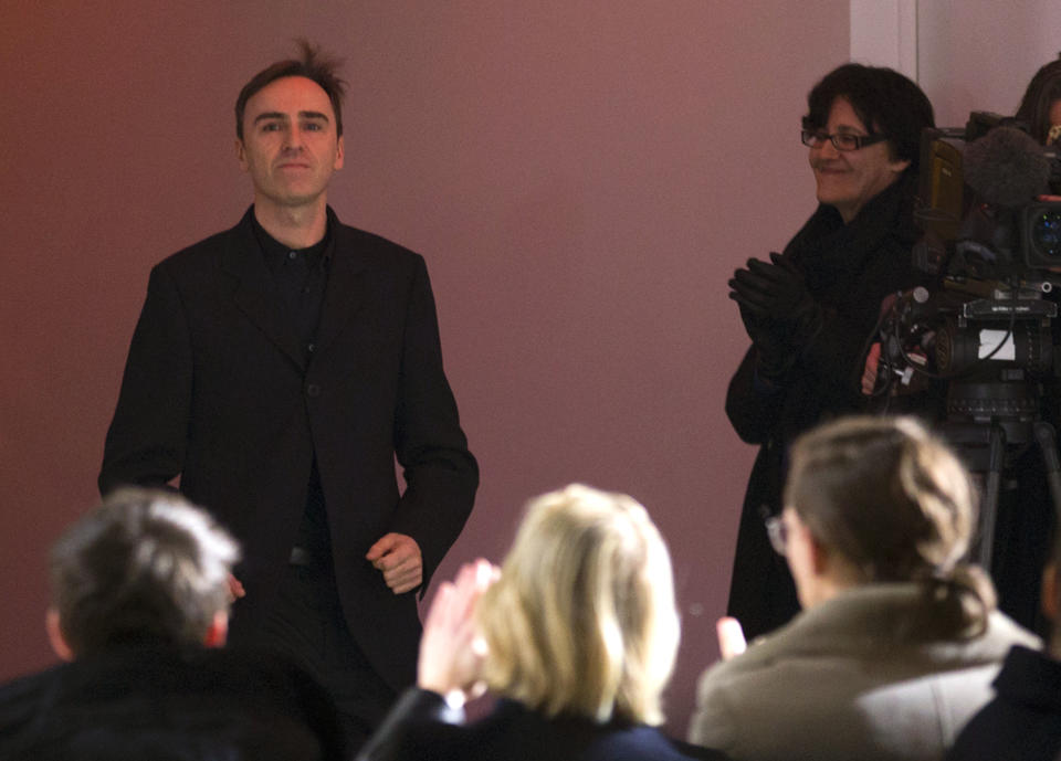 Belgian fashion designer Raf Simons appears at the end of his Men's Spring-Summer 2013 collection, during Paris Fashion Week, in Paris, France, Wednesday, Jan. 16 2013. (AP Photo/ Jacques Brinon)