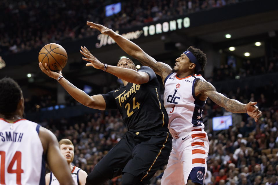 Toronto Raptors guard Norman Powell (24) shoots as Washington Wizards guard Bradley Beal (3) defends during the first half of an NBA basketball game Friday, Jan. 17, 2020, in Toronto. (Cole Burston/The Canadian Press via AP)