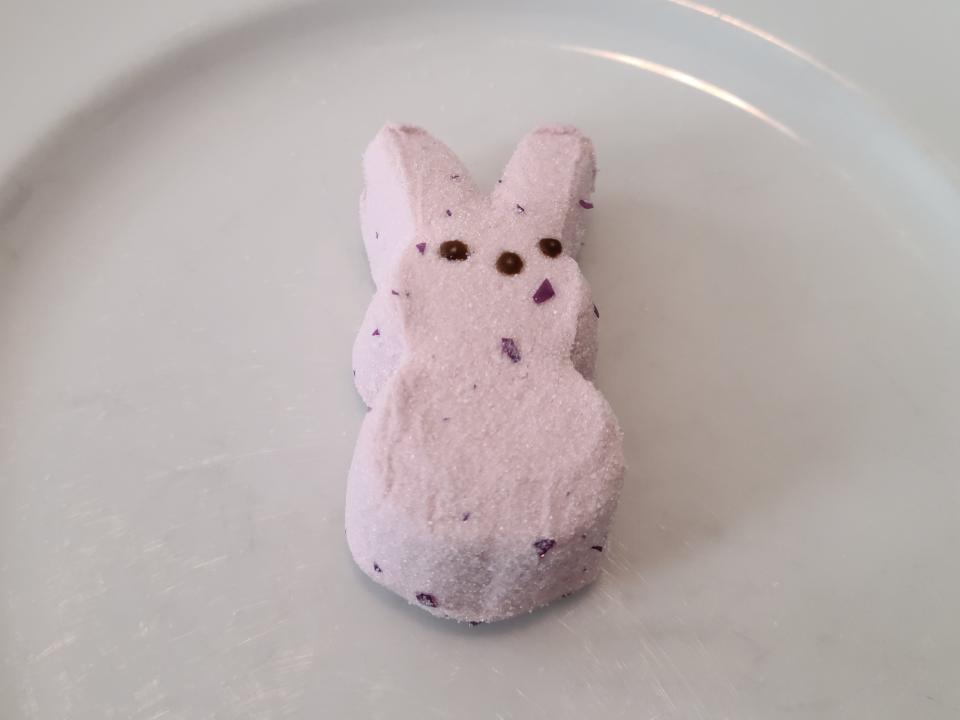 A light-purple sparkly wild berry Peep on a plate