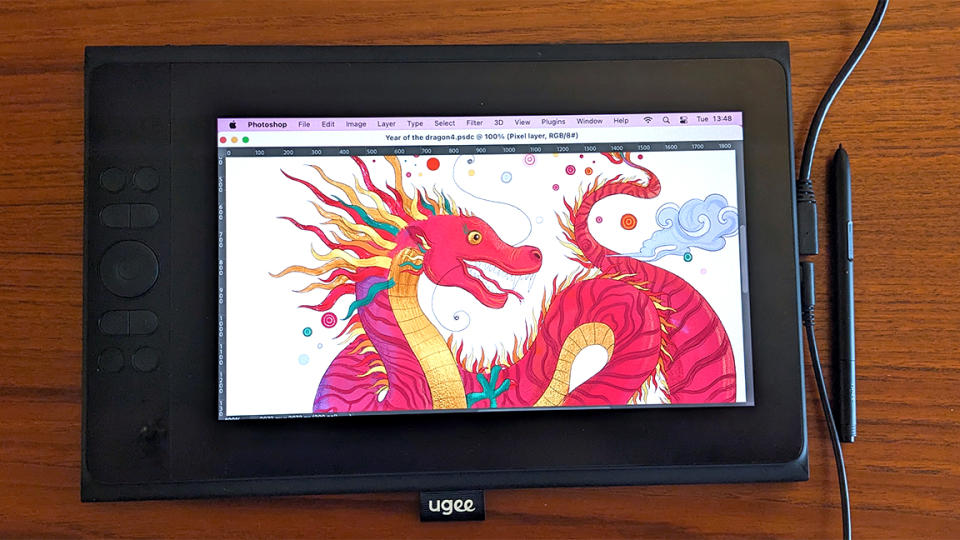 Ugee UE12 Plus review; a drawing tablet on a wooden table with a dragon illustration