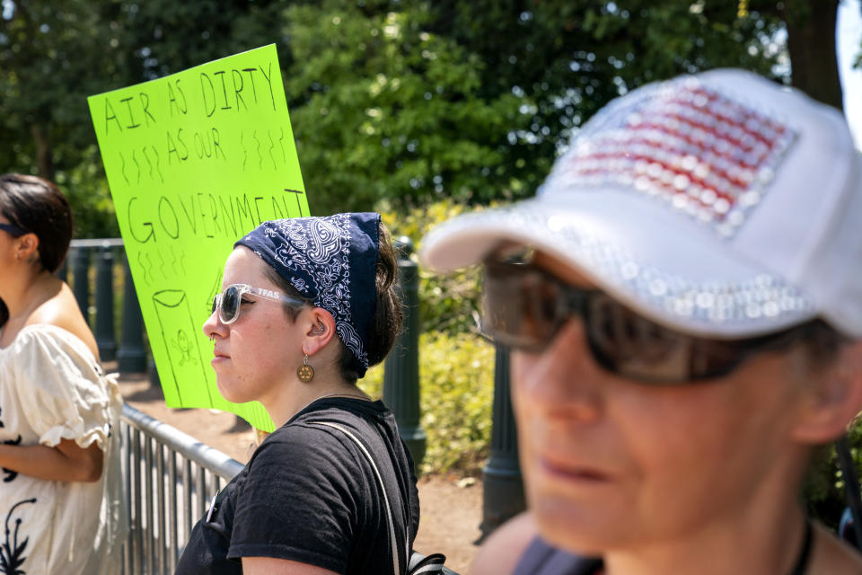 Erin Tinerella, center, of Chicago, who is in Washington for the summer at an internship, protests against climate change after the Supreme Court's EPA decision, Thursday, June 30, 2022, at the Supreme Court in Washington. (AP Photo/Jacquelyn Martin)