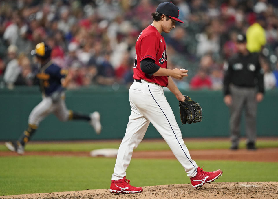 Cleveland Indians starting pitcher Eli Morgan, foreground, waits for Milwaukee Brewers' Luis Urias to run the bases after Urias hit a two-run home run in the fourth inning of a baseball game, Friday, Sept. 10, 2021, in Cleveland. (AP Photo/Tony Dejak)