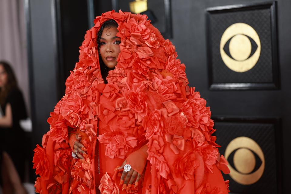 Lizzo's orange Dolce & Gabbana gown was accompanied by an orange eye look.