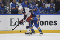 Columbus Blue Jackets' Eric Robinson (50) and St. Louis Blues' Pavel Buchnevich (89) battle for the puck against during the second period of an NHL hockey game Saturday, Nov. 27, 2021, in St. Louis. (AP Photo/Michael Thomas)