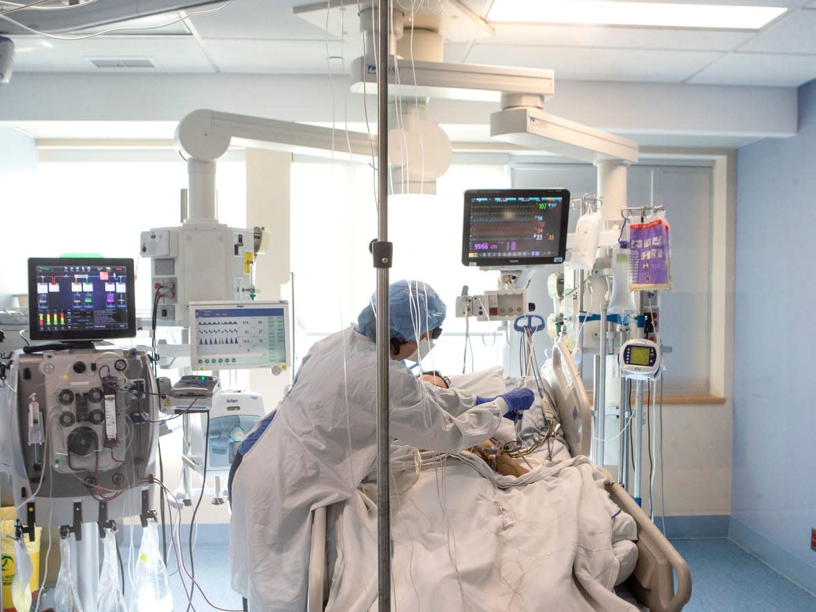 A nurse tends to a patient in the intensive care unit at the Bluewater Health Hospital in Sarnia, Ont. Federal officials say ongoing talks with the provinces on the Canada Health Transfer are going well and that there could be a summit between the prime minister and the premiers in the coming days to finalize an increase. (Chris Young/Canadian Press - image credit)