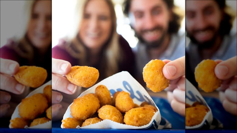 people holding cheese curds