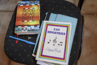 FILE - A hymn book and Bible sit on a chair during a church service at the Cosmopolitan Affirming Community Church, which serves a predominantly LGBTQ congregation, in Nairobi, Kenya, on Oct. 17, 2021. "The mainstream churches – all of them – they actually are totally against it," says Caroline Omolo, associate pastor at the church. It is a rare example of a church in Africa serving a predominantly LGBTQ congregation. (AP Photo/Brian Inganga, File)