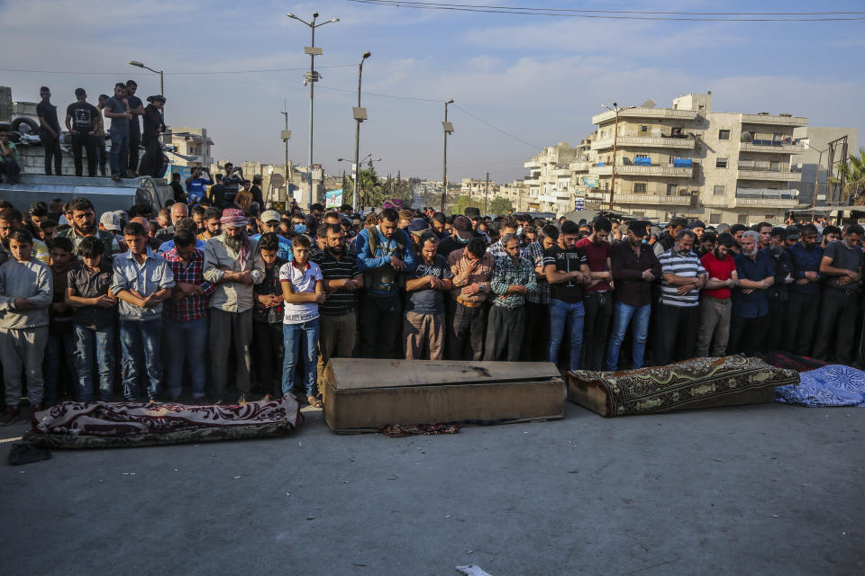 People attend funeral of fighters killed in an airstrike in the town of Idlib, Syria, Monday, Oct. 26, 2020. An airstrike on a rebel training camp in northwestern Syria on Monday killed dozens of Turkish-backed fighters and wounded nearly as many, in one of the heaviest blows to the opposition's strongest groups, a spokesman and a war monitor said. (AP Photo)