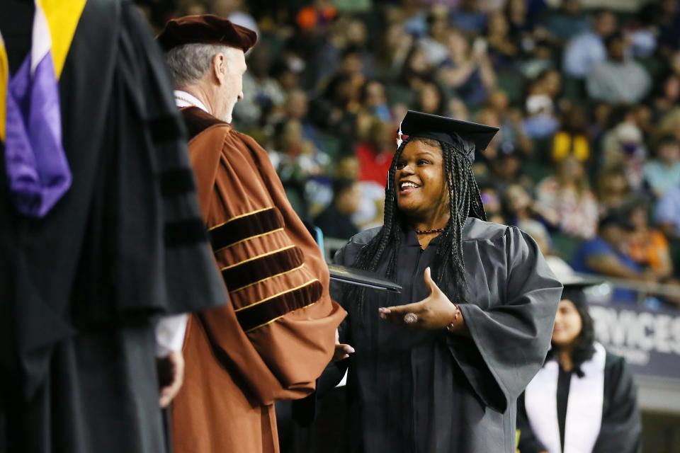 Shilda Fresch receives her associate degree at Austin Community College's graduation ceremony on May 13.