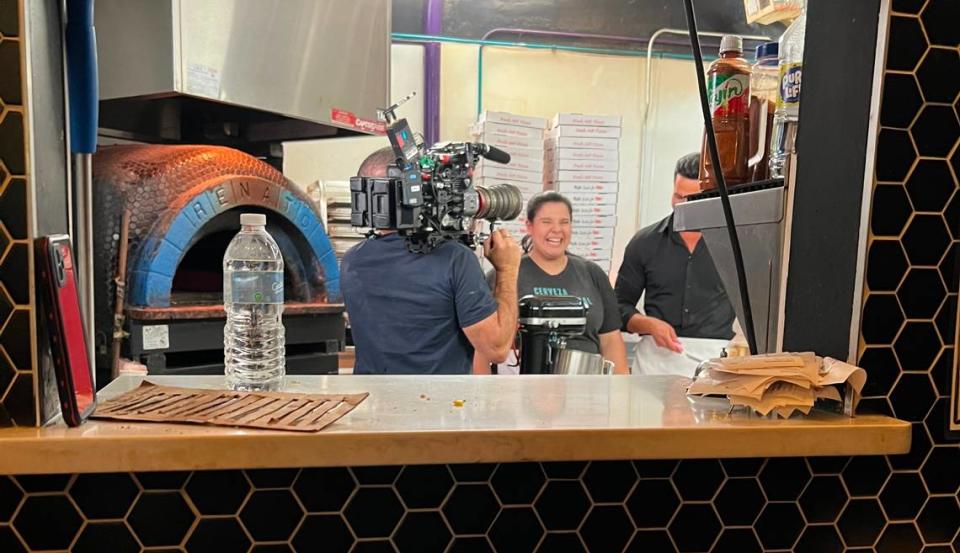 Salud pastry chef Jessica Ceara and “Que Delicia: El Sabor De America” host Jesús Diaz work in the kitchen together during filming.
